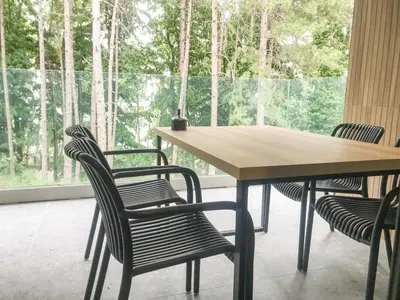 a table and chairs in a room with a large window at Teracite in Varna City