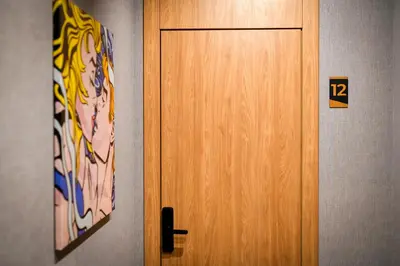 a wooden door with the number twelve next to it at Smart Rooms in Varna City
