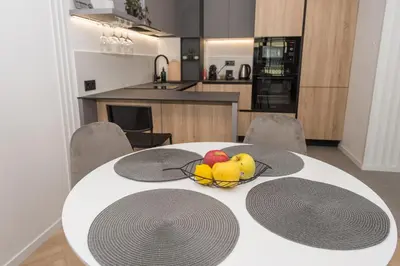 a white table with a bowl of fruit on it at KASHMIR Deluxe apartment with Parking in Burgas City