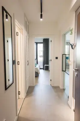 a hallway with a room with a bed and a mirror at KASHMIR Deluxe apartment with Parking in Burgas City