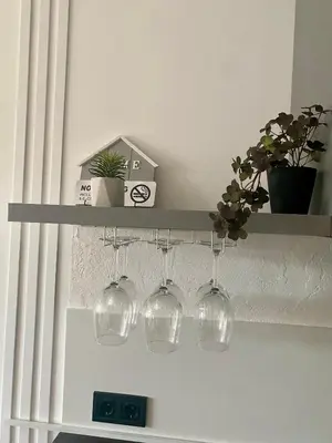a shelf with wine glasses and plants on it at KASHMIR Deluxe apartment with Parking in Burgas City