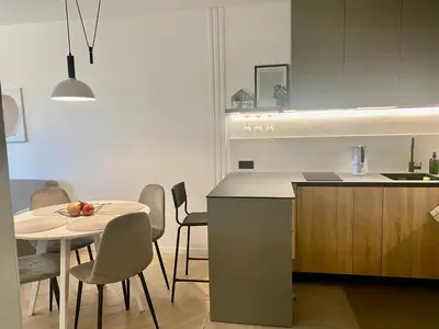 a kitchen with a table and a table and chairs at KASHMIR Deluxe apartment with Parking in Burgas City