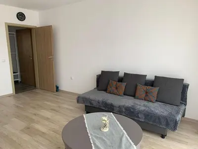a living room with a couch and a table at Sunny holidays in Byala