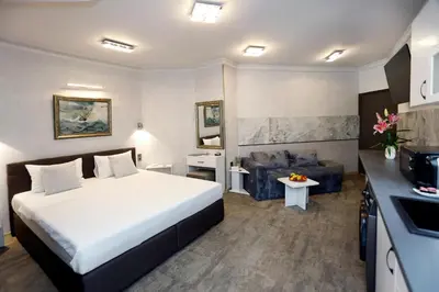 a hotel room with a bed and a couch at Deluxe 3 Studio City Center in Burgas City