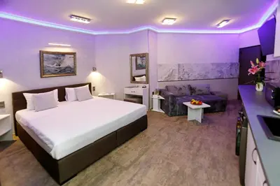 a hotel room with a bed and a couch at Deluxe 3 Studio City Center in Burgas City