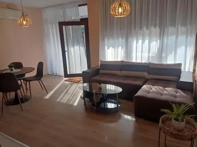 a living room with a couch and a table at Апартамент РАЯ in Sozopol