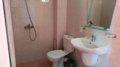 a bathroom with a toilet and a sink and a shower at Guest House Malkata Stopanka in Primorsko