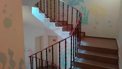 a staircase with a red railing in a room at Guest House Malkata Stopanka in Primorsko