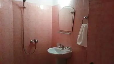 a bathroom with a toilet and a sink and a shower at Guest House Malkata Stopanka in Primorsko