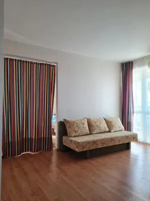 a living room with a couch in front of a window at Entire apartment 4pax , sea view, pool in Ravda