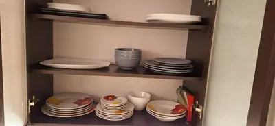 a cabinet filled with plates and bowls and dishes at Entire apartment 4pax , sea view, pool in Ravda