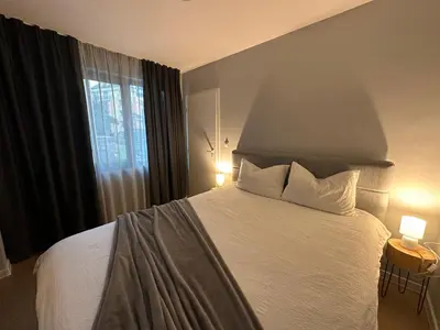a bedroom with a bed with two pillows and a window at Cosy Apartment - Top Location in Burgas City
