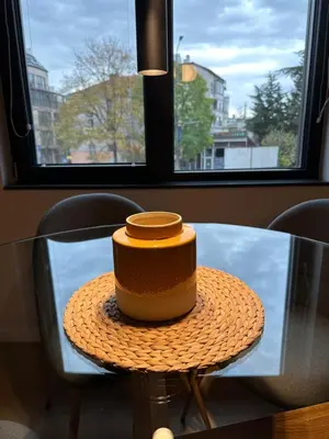 a cake sitting on top of a glass table at Cosy Apartment - Top Location in Burgas City