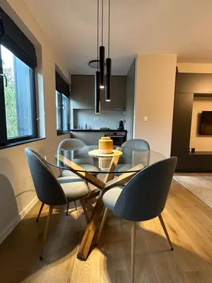a dining room with a glass table and chairs at Cosy Apartment - Top Location in Burgas City