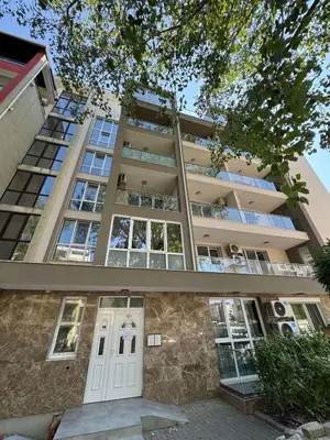 an apartment building with a white door in front of it at VP Martini in Sunny Beach
