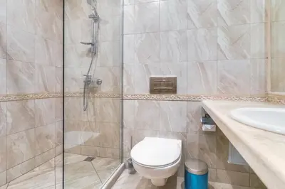 a bathroom with a shower and a toilet and a sink at AT apartment - Sea View in Varna City