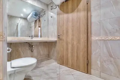 a bathroom with a toilet and a shower at AT apartment - Sea View in Varna City
