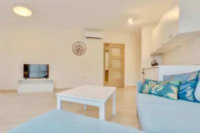a living room with a couch and a table at AT apartment - Sea View in Varna City