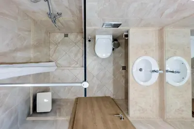 a bathroom with two sinks and a shower at AT apartment - Sea View in Varna City