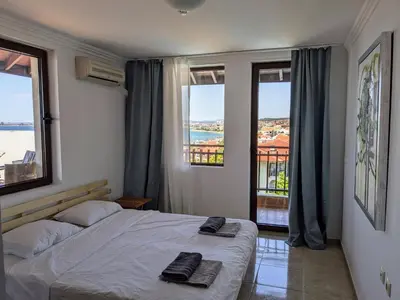 a bedroom with a bed with two towels on it at Beachfront Apartment Sveti Vlas in Sveti Vlas