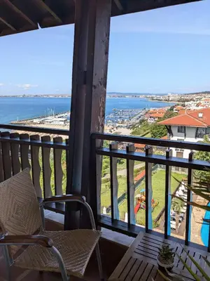 a balcony with a chair and a view of the ocean at Beachfront Apartment Sveti Vlas in Sveti Vlas