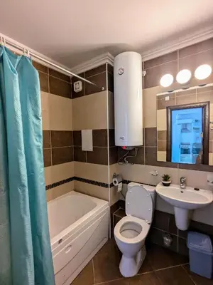 a bathroom with a toilet and a sink and a tub at Beachfront Apartment Sveti Vlas in Sveti Vlas