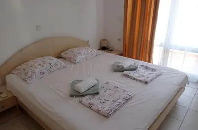 a white bed with four pillows on it at Апартамент Плаж Червенка in Chernomorets
