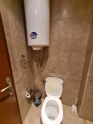 a small bathroom with a toilet in a stall at MitProt Panorama Bay2 Luks Apartment 174 in Sveti Vlas