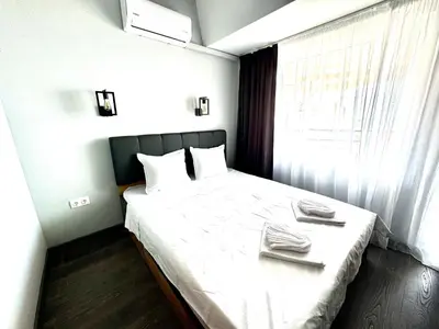 a bedroom with a bed with two towels on it at Апартамент СВЕТИ ВЛАС 1 in Sveti Vlas