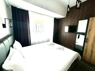 a hotel room with a bed and a window at Апартамент СВЕТИ ВЛАС 1 in Sveti Vlas