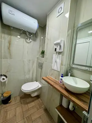 a bathroom with a white toilet and a sink at Студио СВЕТИ ВЛАС 2 in Sveti Vlas