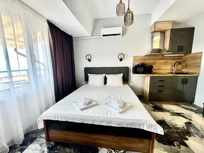 a bedroom with a bed with two towels on it at Студио СВЕТИ ВЛАС 2 in Sveti Vlas
