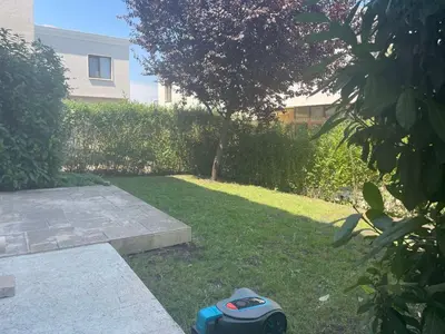 a wheeled object sitting on the grass in a yard at Majestic Villas Pomorie Park in Sarafovo