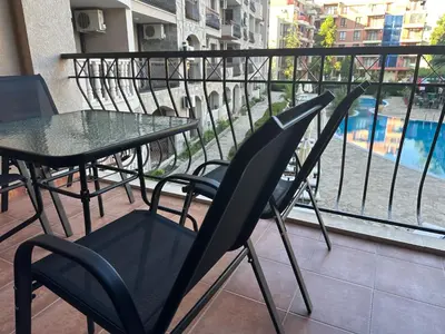 a balcony with a table and chairs on a balcony at Kalia A5 Sunny Beach in Sunny Beach