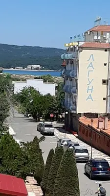 a city street with cars parked in a parking lot at PerlaView in Primorsko