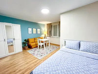 a bedroom with a bed and a table and a couch at Cosy Home in Burgas City