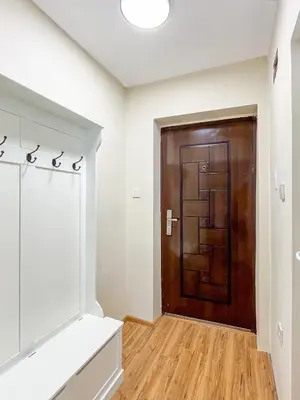 a room with a brown door and a wooden floor at Cosy Home in Burgas City