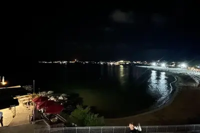 a view of a beach at night with lights at Studio Kikki Sozopol in Sozopol