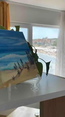 a cake on a table with a view of the ocean at Studio Kikki Sozopol in Sozopol