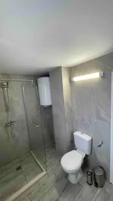 a bathroom with a toilet and a shower at Studio Kikki Sozopol in Sozopol
