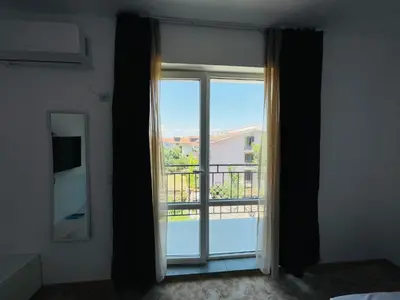 a room with a window with a view of a balcony at Apartments Lozenets in Lozenets