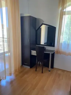 a desk with a monitor and a chair in a room at 2 Bedroom Apartment at Kasandra in Sunny Beach