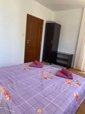 a purple bed with pink pillows on top of it at 2 Bedroom Apartment at Kasandra in Sunny Beach