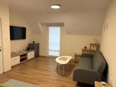 a living room with a couch and a table at Студио за гости При Нана in Burgas City