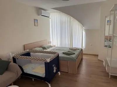 a small bedroom with a bed and a couch at Студио за гости При Нана in Burgas City