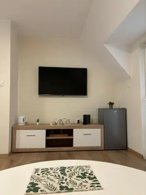 a living room with a flat screen tv on a wall at Студио за гости При Нана in Burgas City