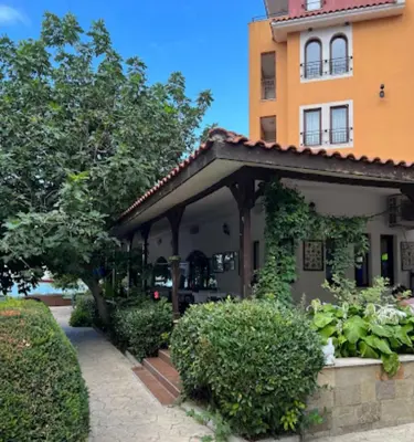 a building with a garden in front of it at Victoria's apartments -Marina Cape - Aheloy in Aheloy