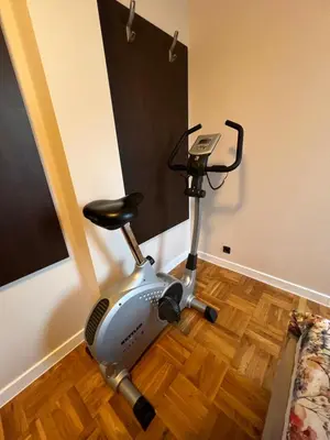 a exercise bike in a room with a wooden floor at Roman Thermae Heritage Penthouse with Garage in Varna City