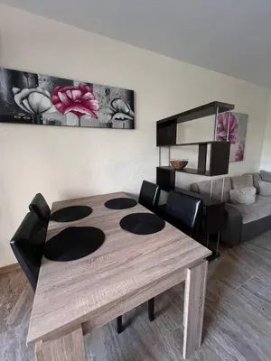 a living room with a wooden table and a couch at Комплекс Амара А4 in Sunny Beach