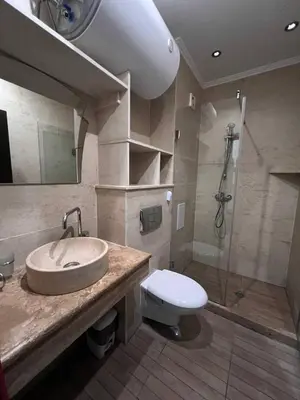 a bathroom with a sink and a toilet and a shower at Комплекс Амара А4 in Sunny Beach